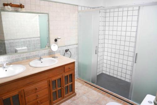 a bathroom with two sinks and a shower at Beautiful apartment private roof terrace in Nerja