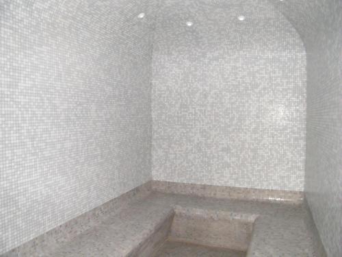 a bathroom with a shower with white tiled walls at Résidence Mer & Golf Tourmalet in La Mongie