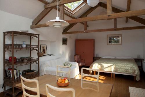 a bedroom with a bed and a table and chairs at Charming old stables studio cottage in Clonakilty