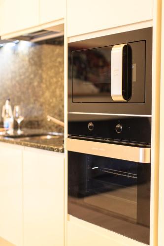 a microwave oven sitting inside of a kitchen at Royal Montesun Apartments in Budva