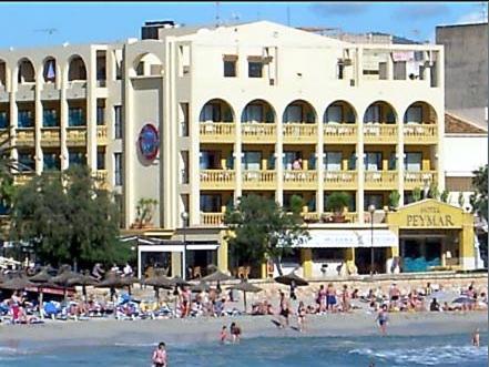 a large building on a beach with people on it at Mix Peymar in S'Illot