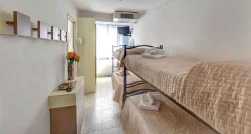 Ένα ή περισσότερα κρεβάτια σε δωμάτιο στο Hotel Niagara Riccione