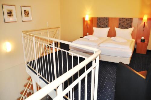 a hotel room with two beds and a staircase at Straelener Hof in Straelen