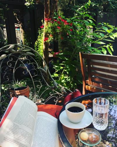 an open book sitting on a table with a cup of coffee at Artemis Selcuk Suites in Selcuk