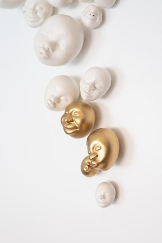 two gold and white pearl balls on a white background at Boutique Hotel Sablon by CW Hotel Collection in Bruges