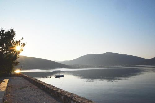 a view of a lake with a boat in the water at blueline guesthouse in Áyios Dhimítrios