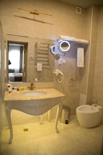 a bathroom with a sink and a toilet at Hotel Uzbekistan in Urganch