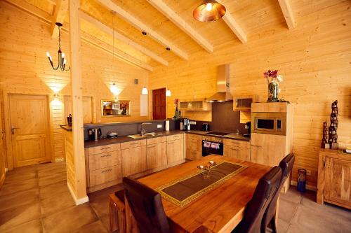 a large wooden kitchen with a wooden table and chairs at Ferienhaus Orchidee in Rieden