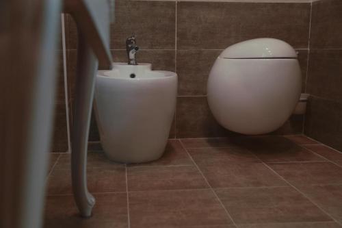 a bathroom with a toilet and a sink at Hotel Uzbekistan in Urganch