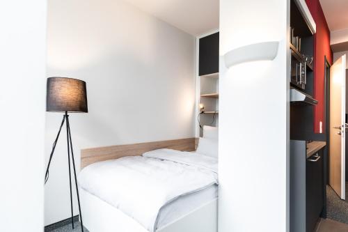 Postel nebo postele na pokoji v ubytování HUB Apartments