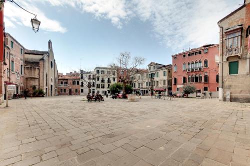 an empty plaza in a city with buildings at Charming Castello Apartments in Venice