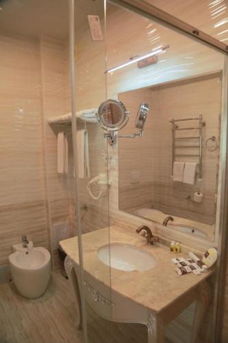 a bathroom with a sink and a shower at Hotel Uzbekistan in Urganch