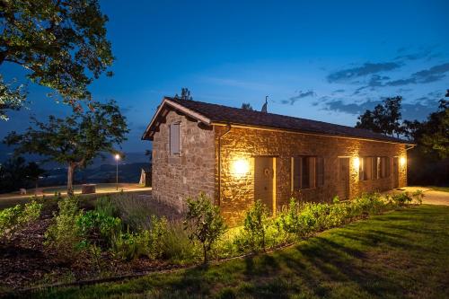 a stone building with lights on it at night at Nikis Resort in Gubbio