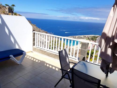 a balcony with a view of the ocean at APT with terrace facing Amadores beach in Amadores