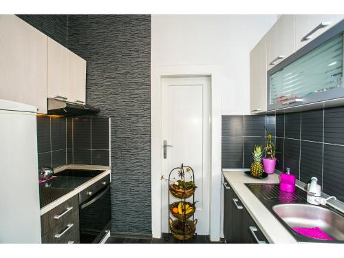 a kitchen with a sink and a counter top at Apartment Liatris in Split
