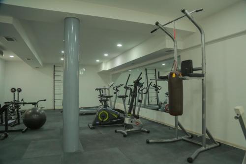 a gym with several exercise equipment in a room at Hotel Uzbekistan in Urganch