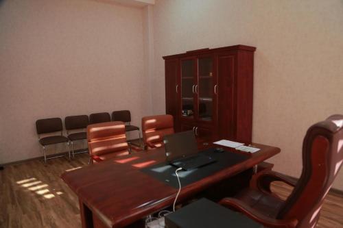 a conference room with a table and chairs and a laptop at Hotel Uzbekistan in Urganch