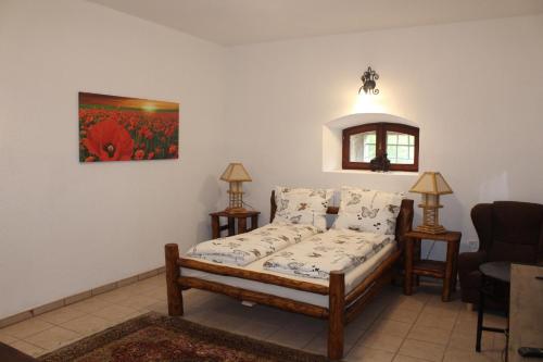 a living room with a bed and a couch at Magtár Vendégház Harsány in Harsány