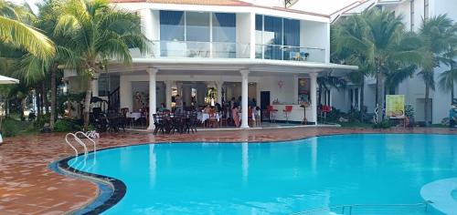a large swimming pool in front of a house at Muine Pacific Resort in Mui Ne