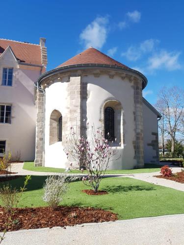 a white house with a round turret at Château Saint-Jean, Relais & Châteaux in Montluçon