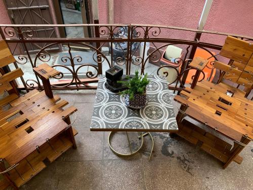 an overhead view of a table and benches on a balcony at Come inn - 24h Self Check-in in Sofia