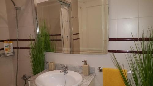 a bathroom with a sink and a mirror at The Apartment in Gran Tarajal