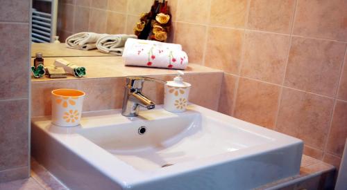a bathroom sink with two cups on top of it at Villa Venezia in Mira