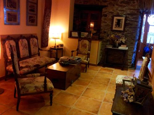 a living room with a couch and chairs and a table at La Casona de Pío in Cudillero