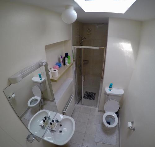 a bathroom with a sink and a shower and a toilet at Cosy Keel Cottage in Keel