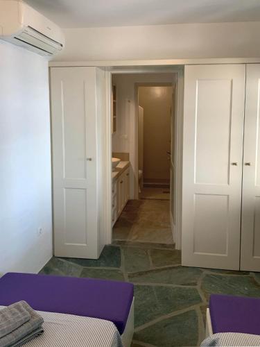 a room with two beds and a room with a bathroom at Aqua Blue, only 100 meters from the beach of Gialiskari in Ioulida