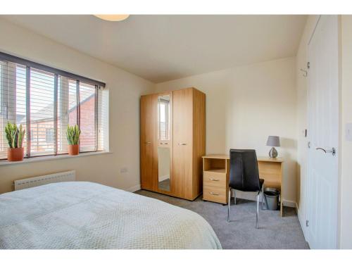 a bedroom with a bed and a desk and a chair at Newly built, splendid house for 5 in Manchester! in Manchester