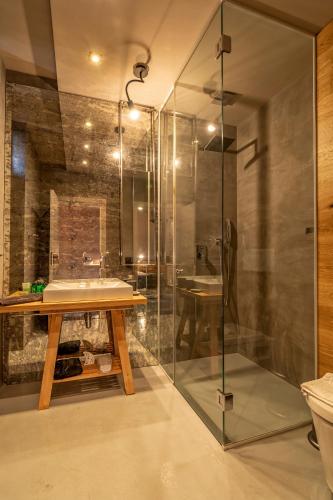 a bathroom with a sink and a glass shower at Design Hotel 36 in Sofia
