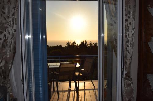 a view of the sunset from the balcony of a house at Markulata in Khalikerí