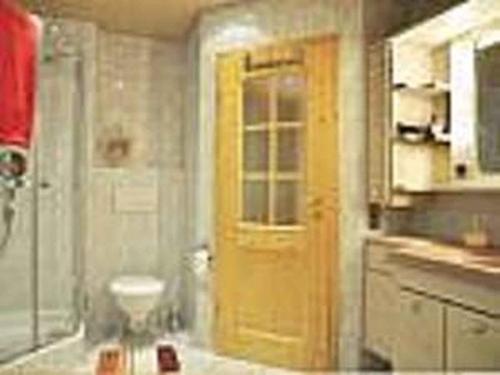 a bathroom with a yellow door and a toilet at Vollmershof in Wolfach