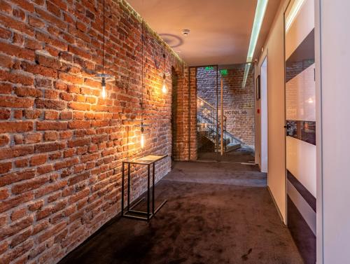 a brick wall with a table next to a brick hallway at Design Hotel 36 in Sofia