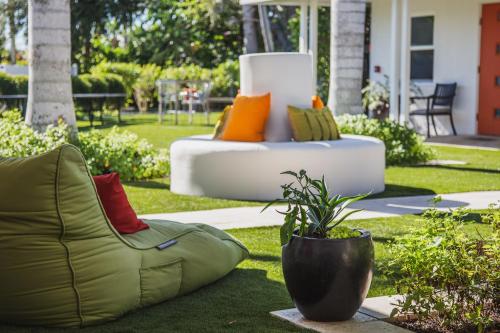 a couch with colorful pillows sitting on the grass at Captiva Beach Resort (open private beach access) in Sarasota