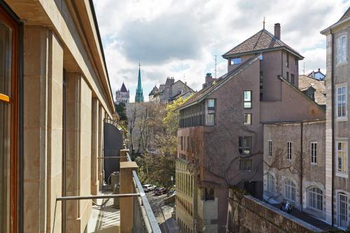 a view of a city from an alley between buildings at Hotel Central in Geneva