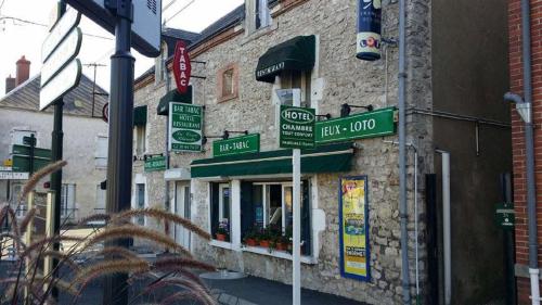 a building with street signs on the side of it at HOTEL DU CYGNE DE LA CROIX BLANCHE in Lailly-en-Val