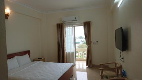 Ένα ή περισσότερα κρεβάτια σε δωμάτιο στο Camellia Hotel