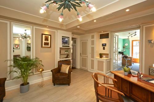 a living room with a desk and a chair and a table at Hotel Central in Geneva