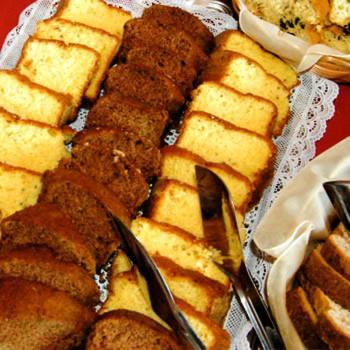 a plate of food with breads on a table at Hotel Santamaria in Guarujá