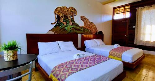 a hotel room with two beds and a table at Amazon City in Pucallpa
