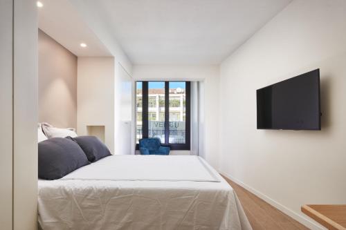 a bedroom with a bed and a flat screen tv at 3P BETWEEN CROISETTE BEACHES AND ANTIBES STREET in Cannes