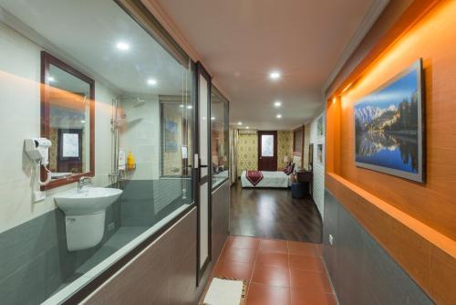 a bathroom with a sink and a toilet in it at Sapa Elegance Hotel in Sapa