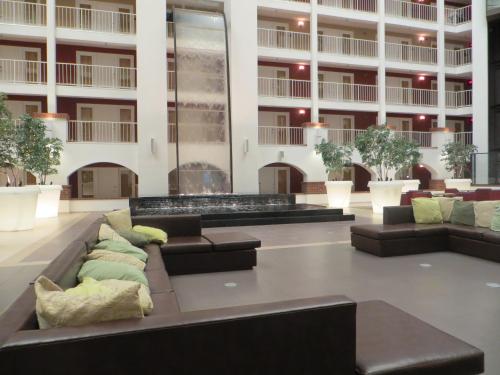 a large lobby with couches and tables in a building at HoteLumiere at the Arch, A Caesars Destination in Saint Louis