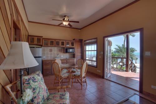 a kitchen with a table and chairs in a room at X'tan Ha- The Waterfront in San Pedro