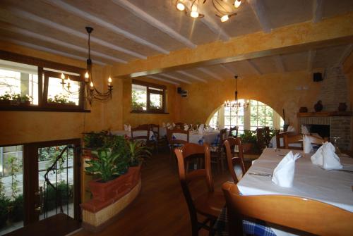 a dining room with tables and chairs in a restaurant at Hotel Town House in Tirana