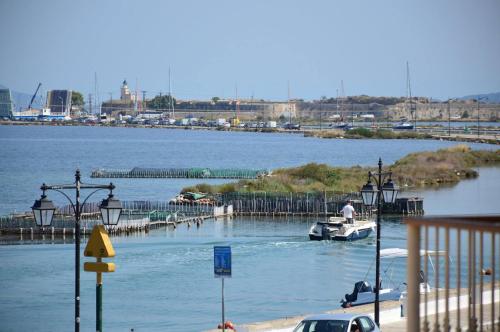 a body of water with boats docked at a dock at Lefkada Family Apartment in Lefkada Town
