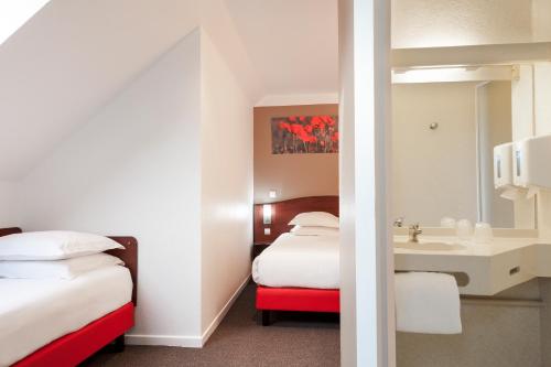 Postel nebo postele na pokoji v ubytování Hôtel Arras Sud