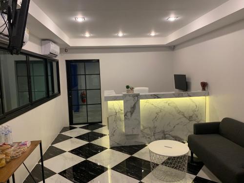 a living room with a couch and a table at 9TY hotel (ninety hotel) in Bangkok